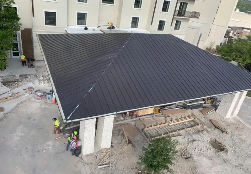 Metal roofing installation team working on a commercial building in Marbletown